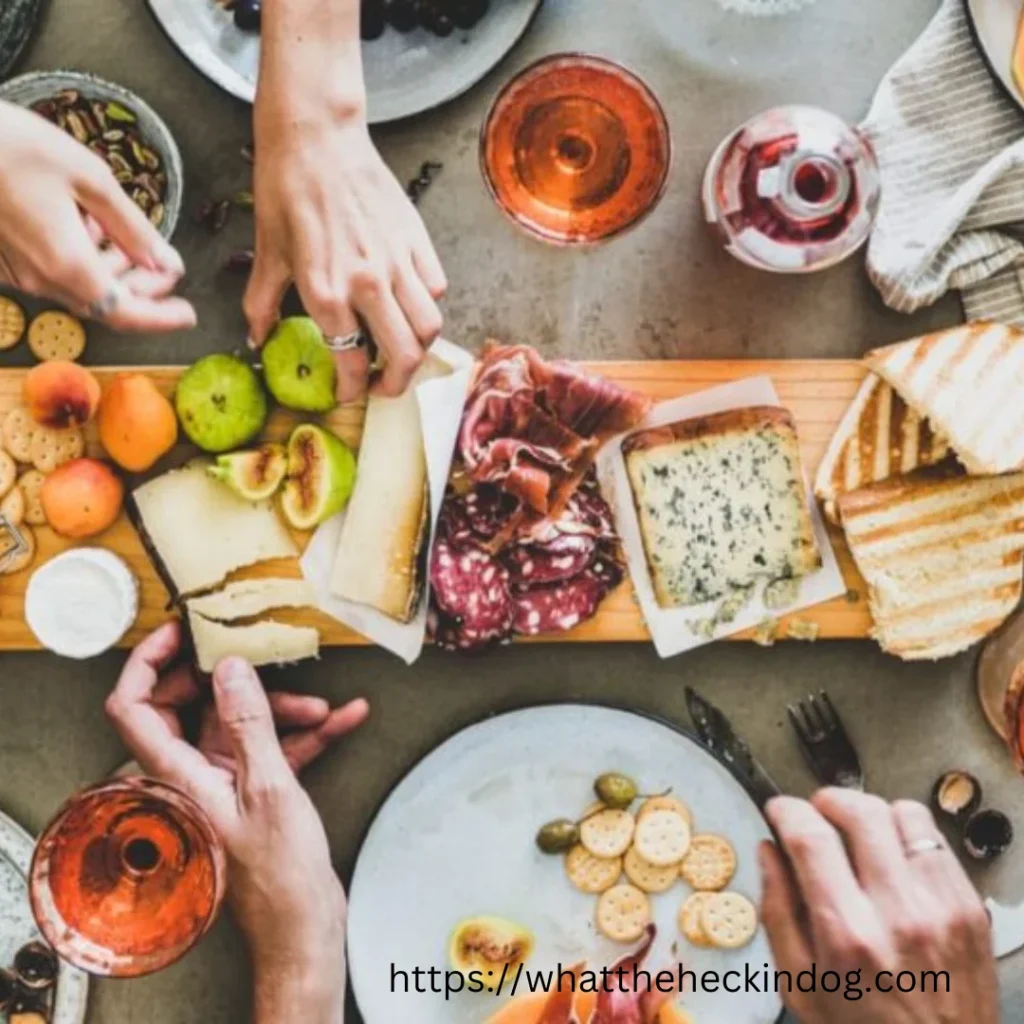 A diverse group of individuals enjoying a meal together at a table, savoring delicious food.